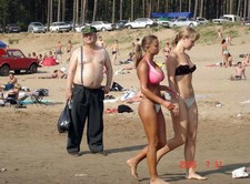 Busty Beach Girl. Some guy snapped a few pics of this lovely, big-chested girl while she's